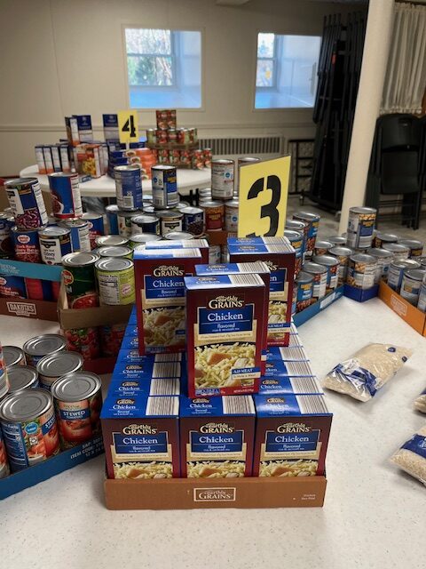 Food Pantry table covered in sauces, soups and noodles.
